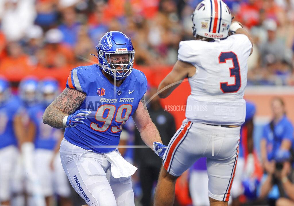 Steve Conner Boise State defensive tackle Scott Matlock (99) pressures Tennessee-Martin quarterback Dresser Winn (3) as Winn throws the ball in the second half of an NCAA college football game, Saturday, Sept. 17, 2022, in Boise, Idaho. (AP Photo/Steve Conner)