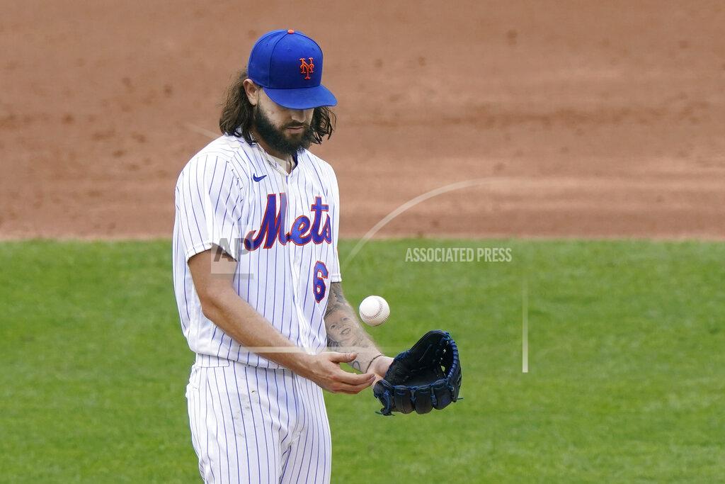 Kathy Willens New York Mets starting pitcher Robert Gsellman tosses a ball as manager Luis Rojas approaches the mound to remove him after allowing four runs during the second inning of a makeup baseball game against the New York Yankees at Citi Field, Thursday, Sept. 3, 2020, in New York. (AP Photo/Kathy Willens)