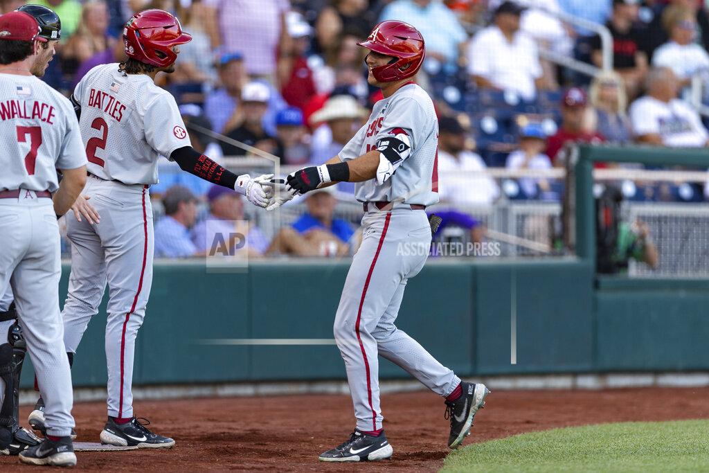 John Peterson Arkansas' Chris Lanzilli (18) gets five from Jalen Battles (2) after his home run in the second inning against Mississippi during an NCAA College World Series baseball game Wednesday, June 22, 2022, in Omaha, Neb. (AP Photo/John Peterson)