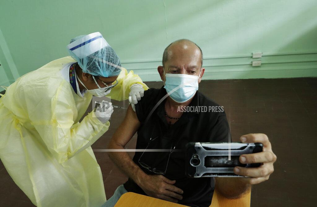 Arnulfo Franco A man takes a selfie as a nurse injects him with a dose of the Pfizer COVID-19 vaccine during a mass vaccination campaign for people over age 60, in Panama City, Tuesday, March 9, 2021. On Tuesday, Panama mark their first year on Pandemic (AP Photo/Arnulfo Franco)
