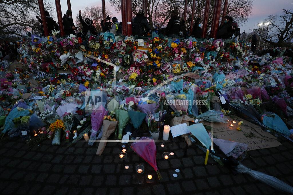 Frank Augstein People gather, at the band stand in Clapham Common, in memory of Sarah Everard, after an official vigil was cancelled, in London, Saturday, March 13, 2021. A serving British police officer accused of the kidnap and murder of a woman in London has appeared in court for the first time. Wayne Couzens, 48, is charged with kidnapping and killing 33-year-old Sarah Everard, who went missing while walking home from a friend’s apartment in south London on March 3. (AP Photo/Frank Augstein)