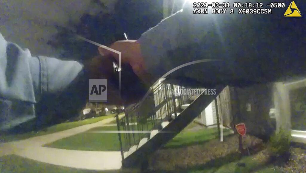 Uncredited In this image taken from Chicago Police body cam video from early Wednesday, March 31, 2021, a Chicago police officer holds out his weapon during a foot chase with Anthony Alvarez in Chicago. Alvarez was fatally shot by police during the incident. Police claim Alvarez, 22, brandished a gun while being chased. (Civilian Office of Police Accountability via AP)