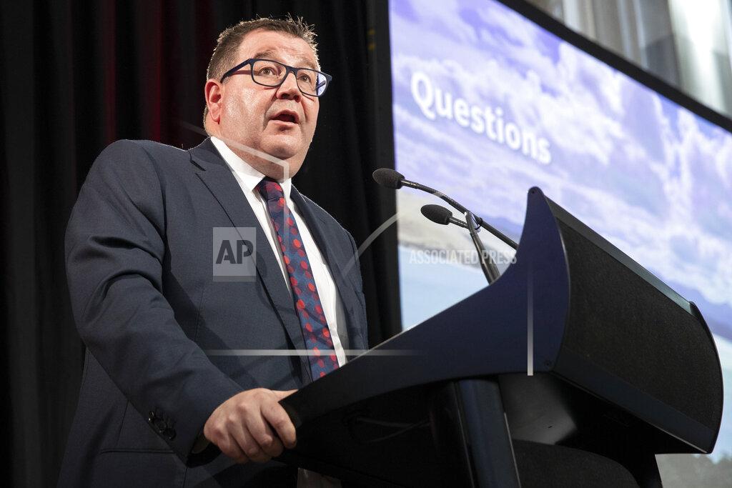 Mark Mitchell New Zealand Finance Minister Grant Robertson appears during his presentation at the Budget lockup in Wellington, New Zealand, Thursday, May 19, 2022. New Zealand's government said Thursday it will hand out an extra few hundred dollars to about half of all adults to help them navigate what it describes as "the peak of the global inflation storm." (Mark Mitchell/NZ Herald via AP)