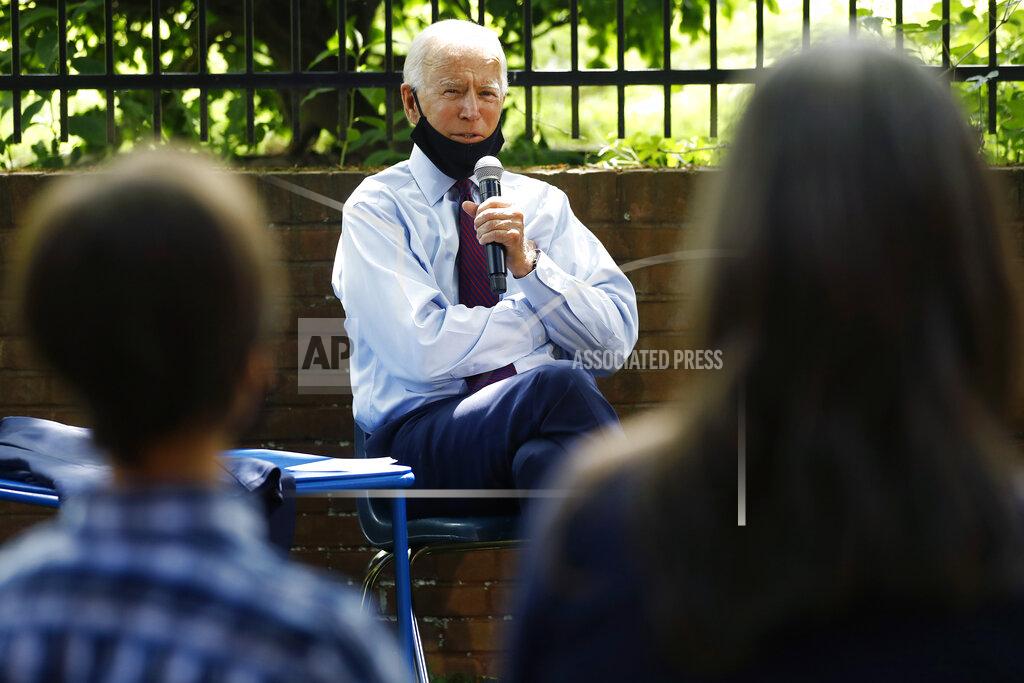 Matt Slocum Democratic presidential candidate, former Vice President Joe Biden, center, speaks to Stacie Ritter, right, and her son, Jan, during a meeting with families who have benefited from the Affordable Care Act, Thursday, June 25, 2020, in Lancaster, Pa. (AP Photo/Matt Slocum)