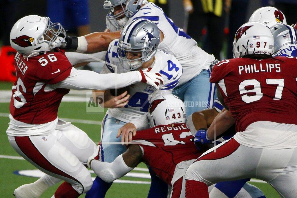 Michael Ainsworth Arizona Cardinals' Reggie Walker (56), Haason Reddick (43) and Jordan Phillips (97) combine to sack Dallas Cowboys' Andy Dalton (14) in the second half of an NFL football game in Arlington, Texas, Monday, Oct. 19, 2020. (AP Photo/Michael Ainsworth)