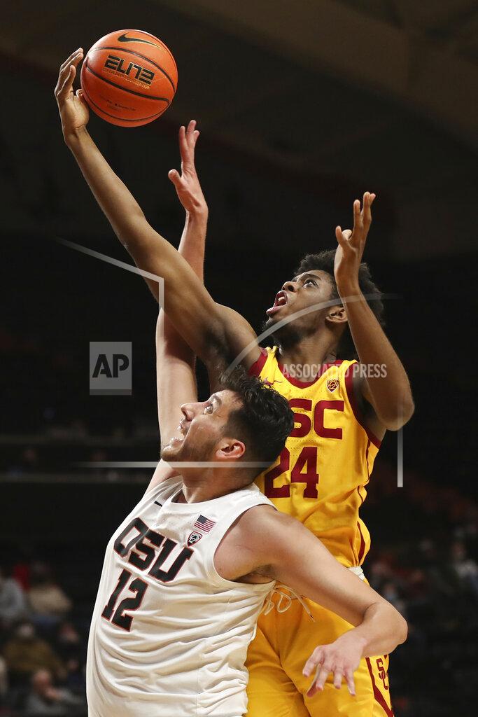 Amanda Loman Oregon State center Roman Silva and Southern California forward Joshua Morgan reach for a rebound during the second half of an NCAA college basketball game Thursday, Feb. 24, 2022, in Corvallis, Ore. Southern California won 94-91. (AP Photo/Amanda Loman)