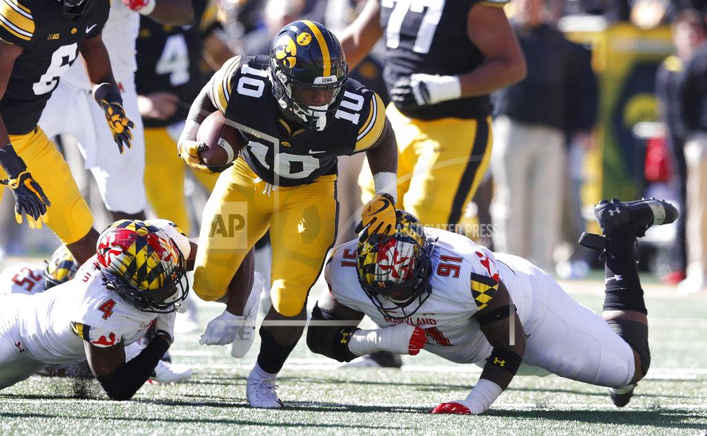 Charlie Neibergall Iowa running back Mekhi Sargent (10) runs between Maryland defenders Darnell Savage Jr., left, and Adam McLean, right, during the first half of an NCAA college football game, Saturday, Oct. 20, 2018, in Iowa City, Iowa. (AP Photo/Charlie Neibergall)