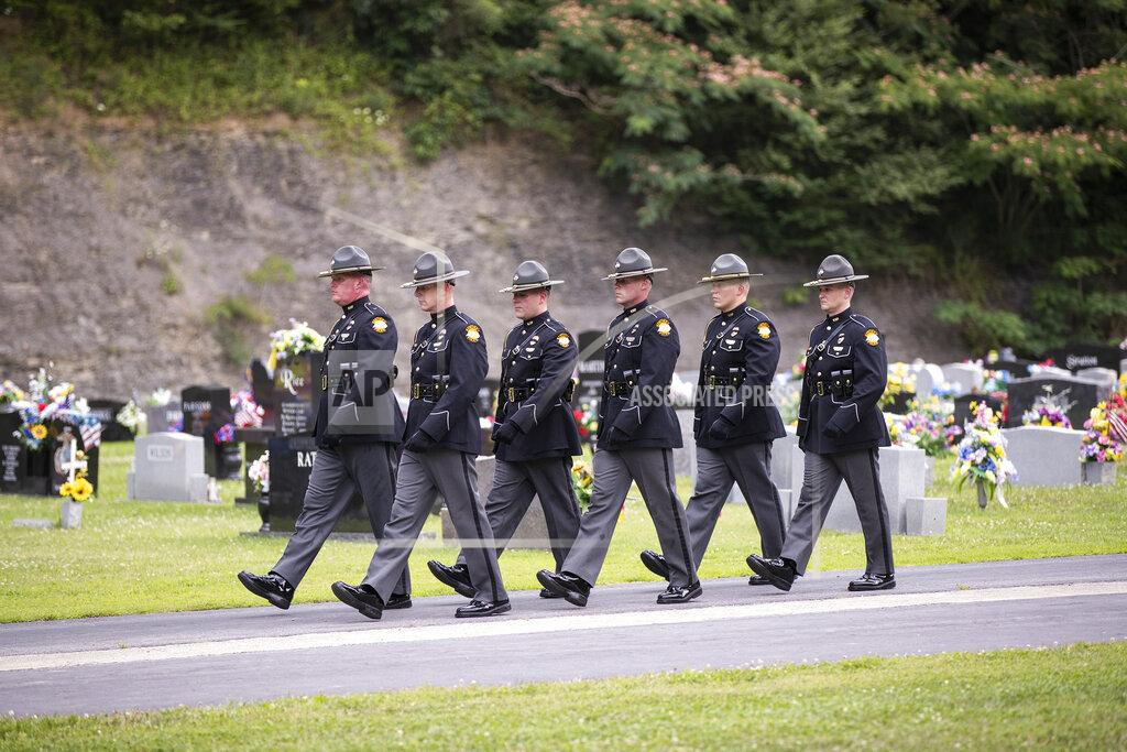 Silas Walker Kentucky state troopers walk out of the cemetery following the ceremony for Floyd County Deputy William Petry in Prestonsburg, Ky., Tuesday, July 5, 2022. Petry and two Prestonsburg city police officers were killed while serving a warrant at a home in the county. (Silas Walker/Lexington Herald-Leader via AP)