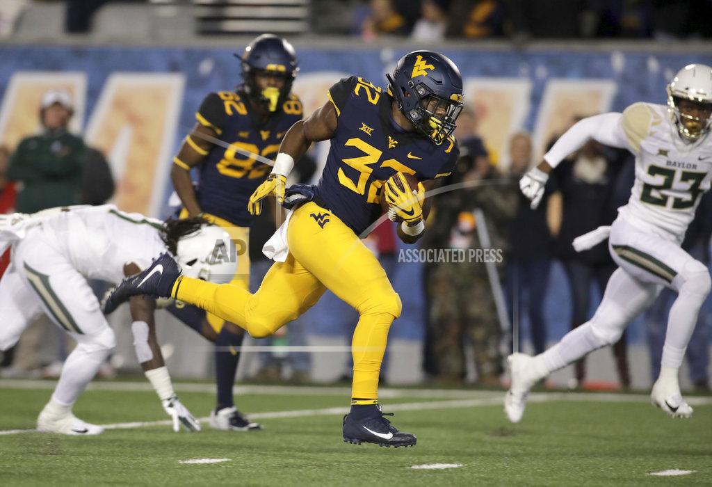 Ray Thompson West Virginia running back Martell Pettaway (32) runs for a touchdown during the first half of an NCAA college football game against Baylor, Thursday, Oct. 25, 2018, in Morgantown, W.Va. (AP Photo/Raymond Thompson)