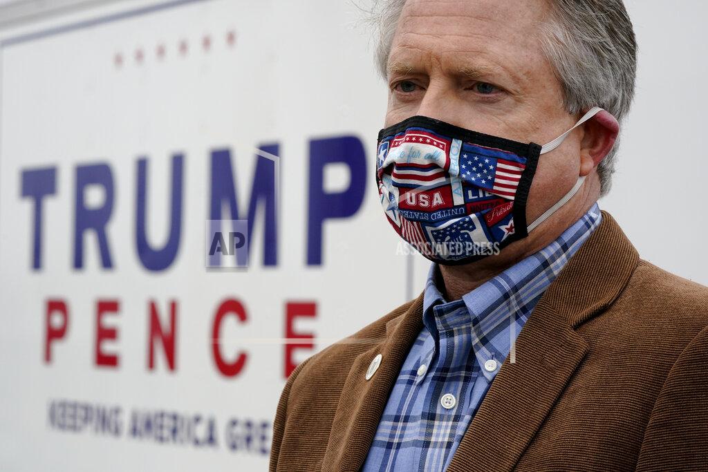 Charlie Riedel U.S. Rep. Roger Marshall, R-Kan., wearing a mask, talks to the media while attending a Concerned Women for America event outside a gun store in Kansas City, Kan. Wednesday, Oct. 21, 2020. Marshall is facing stiff competition from state Sen. Barbara Bollier in the race to fill an open Senate seat in Kansas. (AP Photo/Charlie Riedel)