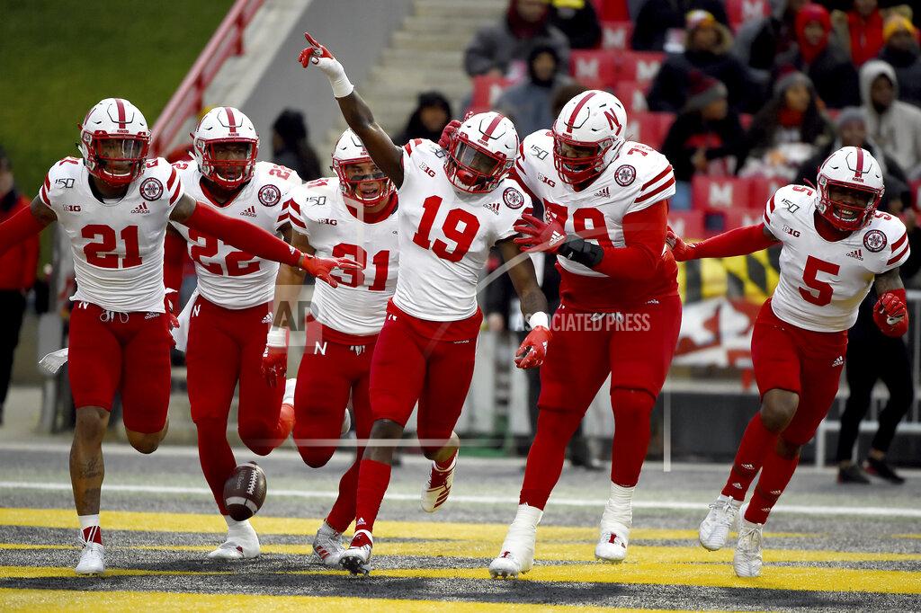 Will Newton FILE - In this Saturday, Nov. 23, 2019, file photo, Nebraska safety Marquel Dismuke (19) celebrates with teammates after recovering a fumble from Maryland running back Javon Leake (20) during the first half of an NCAA college football game against Maryland, in College Park, Md. Nebraska's 24-sport program has about 600 athletes and is one of a handful that makes money. Though a 10% budget cut was announced recently, the program is able to absorb the cost of coronavirus testing, in part because of its affiliation with the university’s medical school.(AP Photo/Will Newton, File)