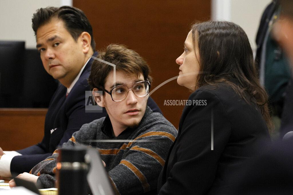 Amy Beth Bennett Marjory Stoneman Douglas High School shooter Nikolas Cruz speaks with sentence mitigation specialist Kate O'Shea, a member of the defense team, as Chief Assistant Public Defender David Wheeler is shown at left during jury selection in the penalty phase of his trial at the Broward County Courthouse in Fort Lauderdale on Monday, May 23, 2022. Cruz previously plead guilty to all 17 counts of premeditated murder and 17 counts of attempted murder in the 2018 shootings. (Amy Beth Bennett/South Florida Sun Sentinel via AP, Pool)