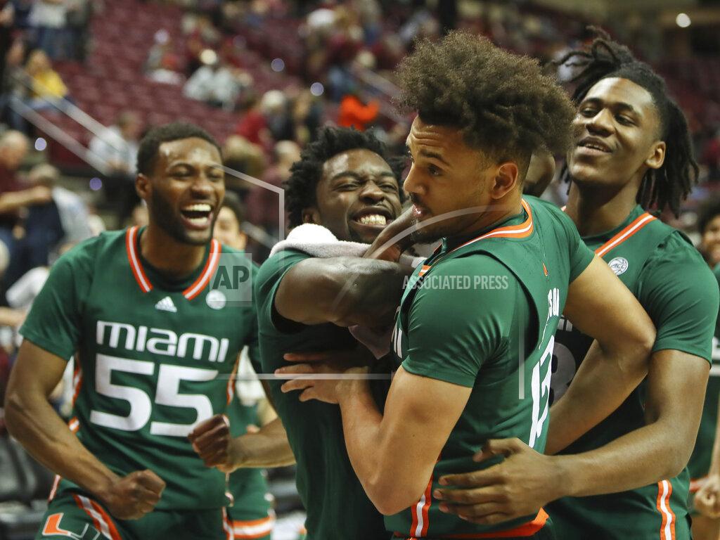 Phil Sears Miami guard Jakai Robinson (13) is congratulated by teammates after making a difficult basket in the second half of an NCAA college basketball game against Florida State in Tallahassee, Fla., Tuesday, Jan. 24, 2023. (AP Photo/Phil Sears)