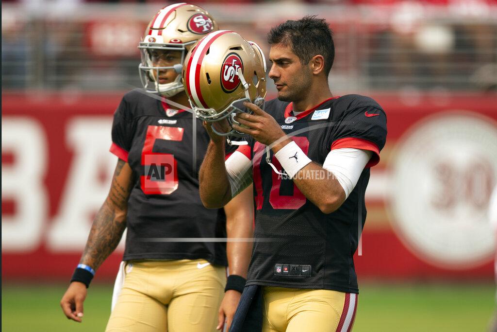 D. Ross Cameron San Francisco 49ers quarterbacks Trey Lance (5) and Jimmy Garoppolo (10) walk across the field during an NFL football open practice, Saturday, Aug. 7, 2021, in Santa Clara, Calif. (AP Photo/D. Ross Cameron)