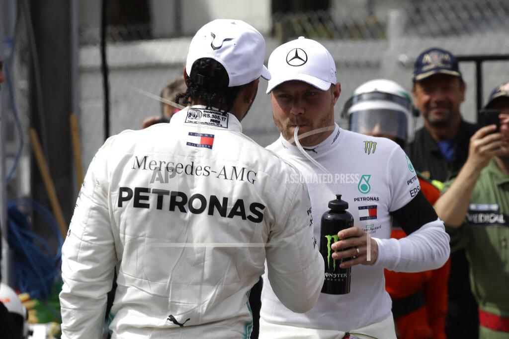 Luca Bruno Mercedes driver Lewis Hamilton of Britain, left congratulates with his teammate driver Valtteri Bottas of Finland, after the qualifying session at the Monaco racetrack, in Monaco, Saturday, May 25, 2019. The Formula one race will be held on Sunday. (AP Photo/Luca Bruno)