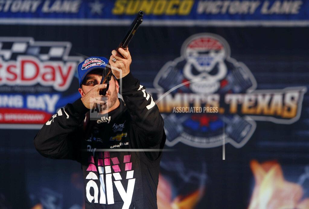 Lm Otero Jimmie Johnson (48) aims a rifle in victory lane after taking the pole position for the NASCAR Cup Series auto race at Texas Motor Speedway in Fort Worth, Texas, Friday, March 29, 2019. (AP Photo/LM Otero)