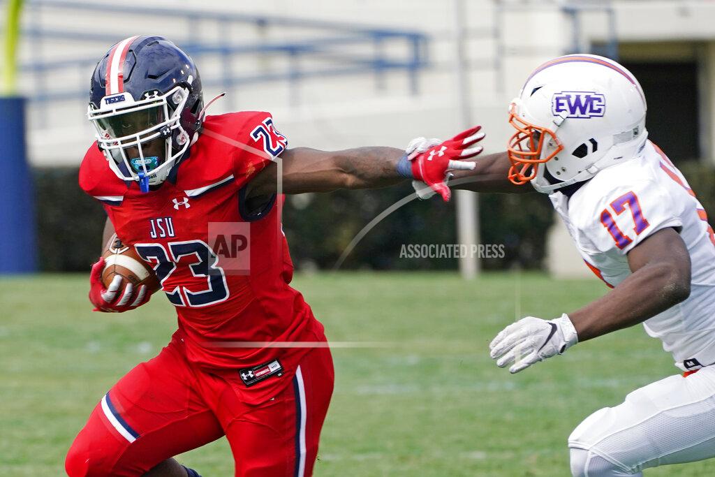 Jackson State running back Kymani Clarke (23) fights off a tackle attempt by Edward Waters linebacker Derrick Nicholson (17) during the first half of an NCAA college football in Jackson, Miss., Sunday, Feb. 21, 2021. The game marked the head coaching debut of Jackson State football coach Deion Sanders. (AP Photo/Rogelio V. Solis)