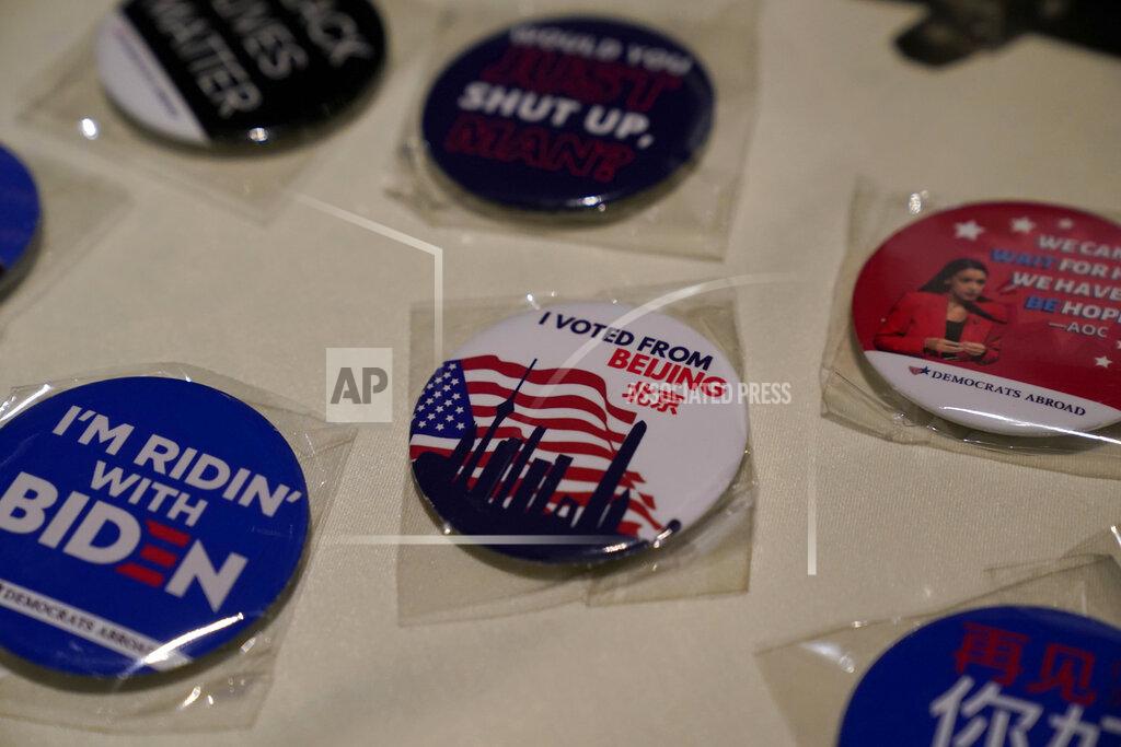 Ng Han Guan Badges are displayed at an election watch event held by Democrats Abroad at a restaurant in Beijing, China on Wednesday, Nov. 4, 2020. President Donald Trump and his Democratic challenger, Joe Biden, are in a tight battle for the White House. (AP Photo/Ng Han Guan)