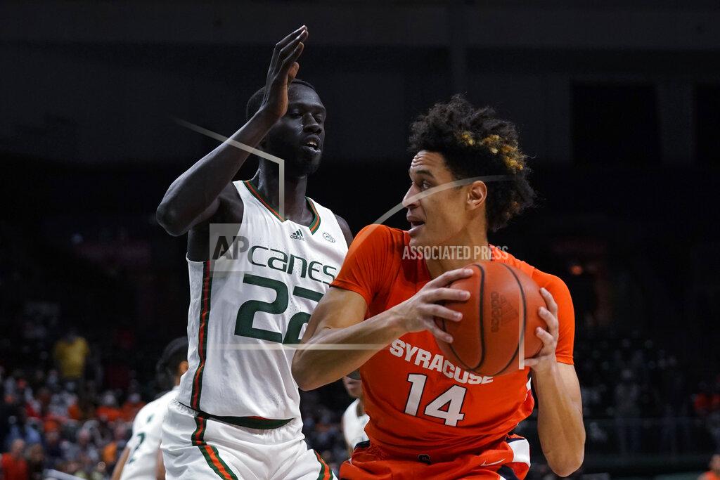 Wilfredo Lee Syracuse center Jesse Edwards (14) looks for an opening past Miami forward Deng Gak (22) during the first half of an NCAA college basketball game, Wednesday, Jan. 5, 2022, in Coral Gables, Fla. (AP Photo/Wilfredo Lee)