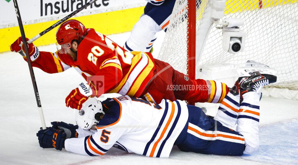 Jeff Mcintosh Edmonton Oilers defenseman Cody Ceci, bottom, and Calgary Flames forward Blake Coleman collide during the third period of Game 5 of an NHL hockey second-round playoff series Thursday, May 26, 2022, in Calgary, Alberta. (Jeff McIntosh/The Canadian Press via AP)