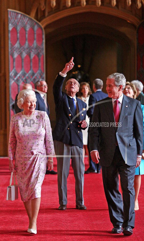 Nick Ray FILE - In this June 15, 2008 file photo, Queen Elizabeth II and Prince Philip, the Duke of Edinburgh, pointing, walk with U.S. President George Bush and his wife Laura, in St George's Hall, Windsor Castle, in Windsor, England. (Nick Ray, Pool Photo via AP, File)