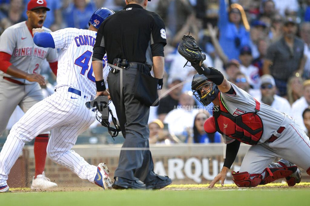 Paul Beaty Cincinnati Reds catcher Aramis Garcia holds up the ball after applying the tag as Chicago Cubs' Willson Contreras (40) scored during the first inning of a baseball game Wednesday, June 29, 2022, in Chicago. (AP Photo/Paul Beaty)