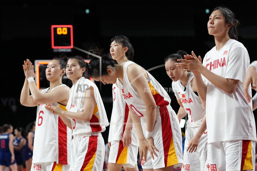 Eric Gay China walk off the court following their loss to Serbia in a women's basketball quarterfinal game at the 2020 Summer Olympics, Wednesday, Aug. 4, 2021, in Saitama, Japan. (AP Photo/Eric Gay)