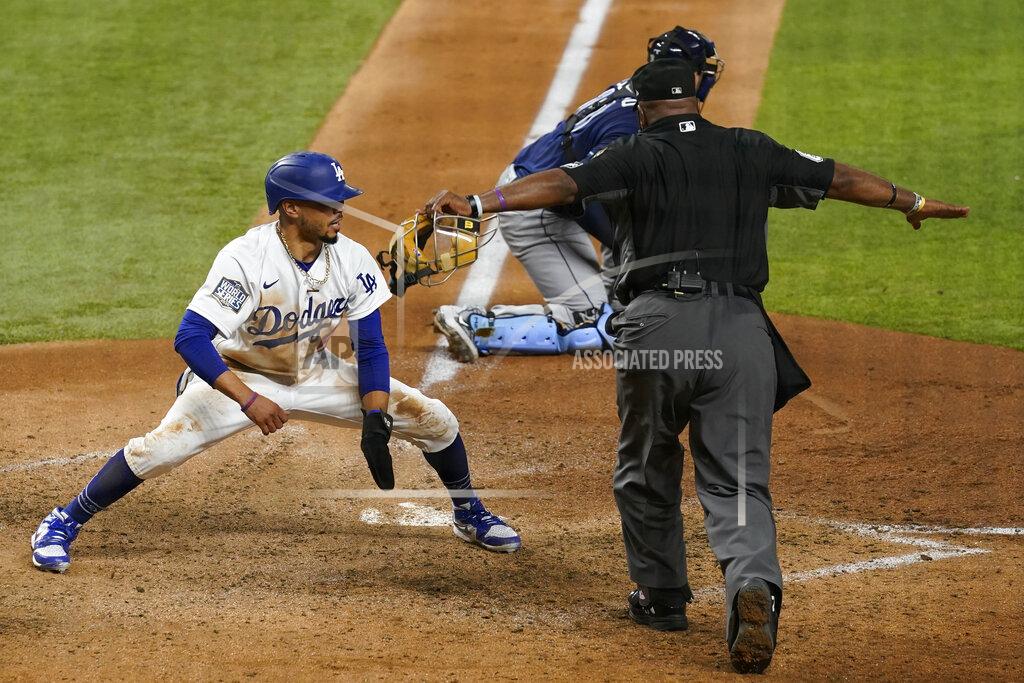 Eric Gay Los Angeles Dodgers' Mookie Betts scores on a fielders choice by Max Muncy during the fifth inning in Game 1 of the baseball World Series against the Tampa Bay Rays Tuesday, Oct. 20, 2020, in Arlington, Texas. (AP Photo/Eric Gay)