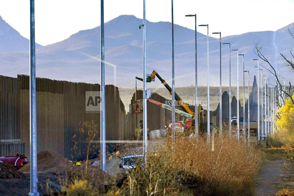 Matt York FILE - Crews construct a section of border wall in San Bernardino National Wildlife Refuge, Tuesday, Dec. 8, 2020, in Douglas, Ariz. President Biden on Wednesday ordered a "pause" on all wall construction within a week, one of 17 executive edicts issued on his first day in office, including six dealing with immigration. The order leaves projects across the border unfinished and under contract after Trump worked feverishly last year to reach 450 miles, a goal he announced was achieved eight days before leaving office. (AP Photo/Matt York)