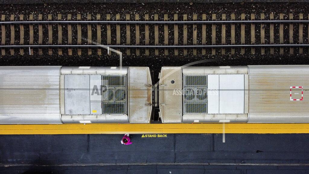 David Goldman A lone passenger boards the commuter train toward Boston at rush hour Monday, March 30, 2020, in Attleboro, Mass. It's a scene playing out all over the world. The empty streets, the silent playgrounds and the lone commuter. Rush hour feels more like hush hour. (AP Photo/David Goldman)