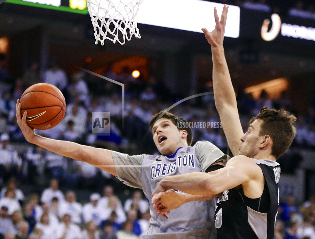 Nati Harnik FILE- In this March 8, 2014, file photo, Creighton's Doug McDermott (3) goes for a layup against Providence's Carson Desrosiers, right, in the second half of an NCAA college basketball game in Omaha, Neb. McDermott was selected as one of the top college basketball players of the decade. (AP Photo/Nati Harnik, File)