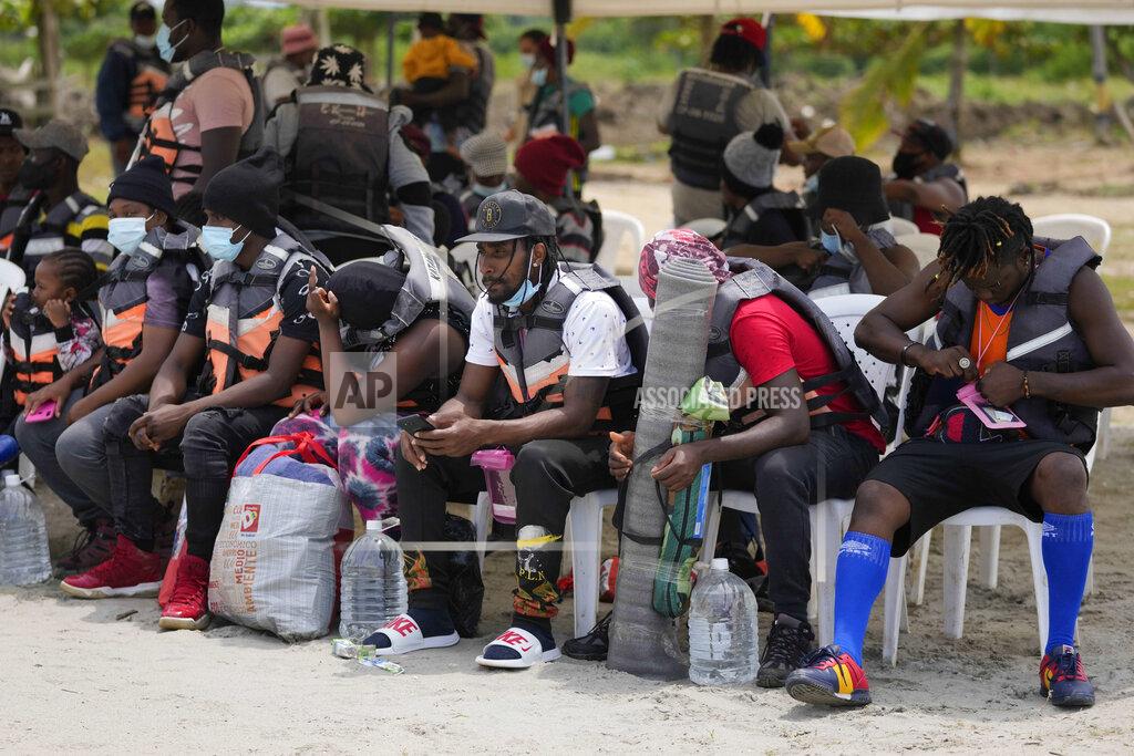 Fernando Vergara Haitian migrants prepare to board boats in Necocli, Colombia, Monday, Sept. 13, 2021. Migrants have been gathering in Necocli as they move north to Acandi, near Colombia's border with Panama, on their journey to the U.S. border. (AP Photo/Fernando Vergara)