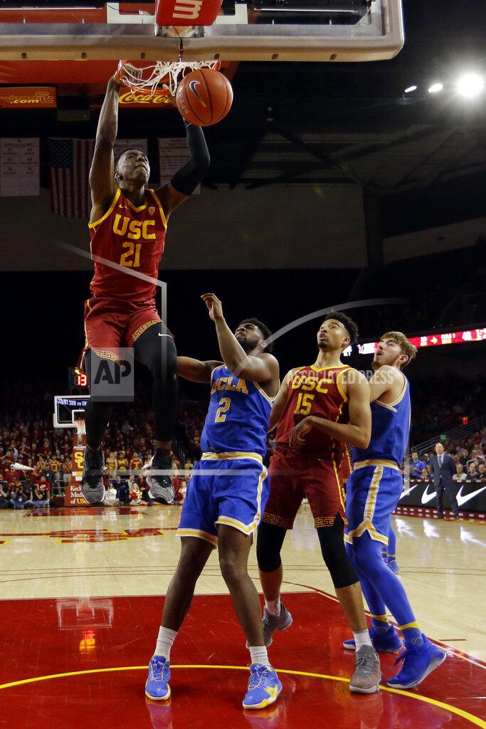 Marcio Jose Sanchez Southern California forward Onyeka Okongwu (21) dunks against UCLA during the second half of an NCAA college basketball game Saturday, March 7, 2020, in Los Angeles. (AP Photo/Marcio Jose Sanchez)