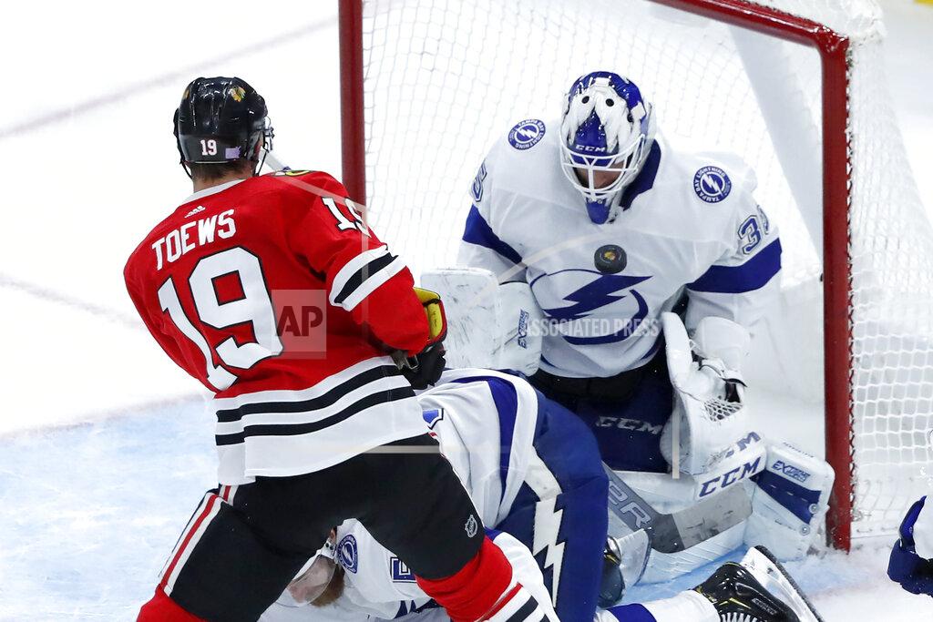 Tampa Bay Lightning goaltender Curtis McElhinney (35) makes a chest save on a shot by Chicago Blackhawks' Jonathan Toews during the second period of an NHL hockey game Thursday, Nov. 21, 2019, in Chicago. (AP Photo/Charles Rex Arbogast)