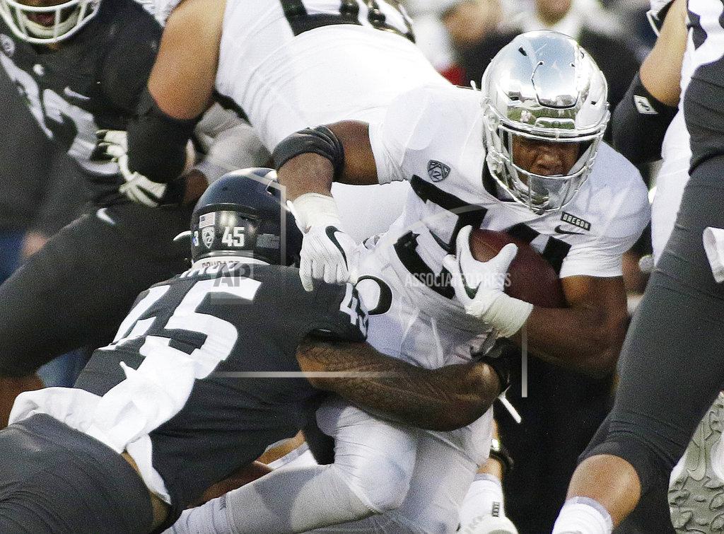 Young Kwak Washington State defensive lineman Logan Tago, left, tackles Oregon running back CJ Verdell during the first half of an NCAA college football game in Pullman, Wash., Saturday, Oct. 20, 2018. (AP Photo/Young Kwak)
