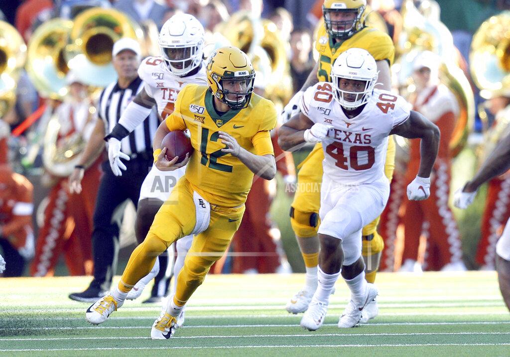 Richard W. Rodriguez Baylor quarterback Charlie Brewer (12) runs the ball as he is pursued by Texas linebacker Ayodele Adeoye (40) In an NCAA football game Saturday, Nov. 23, 2019, in Waco, Texas. (AP Photo/Richard W. Rodriguez)