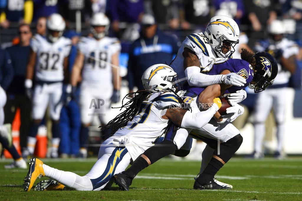Nick Wass Los Angeles Chargers strong safety Jahleel Addae, left, and free safety Derwin James tackle Baltimore Ravens wide receiver Willie Snead in the first half of an NFL wild card playoff football game, Sunday, Jan. 6, 2019, in Baltimore. (AP Photo/Nick Wass)