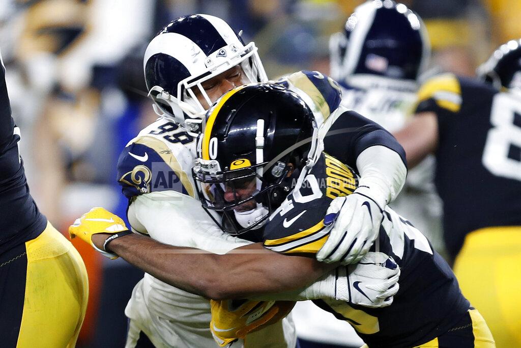 Keith Srakocic Los Angeles Rams defensive tackle Aaron Donald (99) tackles Pittsburgh Steelers running back Tony Brooks-James (40) during the second half of an NFL football game in Pittsburgh, Sunday, Nov. 10, 2019. (AP Photo/Keith Srakocic)