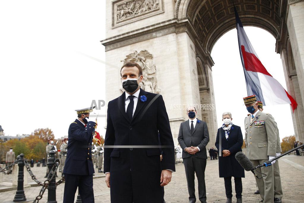 Yoan Valat French President Emmanuel Macron leaves after attending a ceremony under the Arc de Triomphe during Armistice Day ceremonies marking the end of World War I, in Paris, Wednesday, Nov. 11, 2020. French President Emmanuel Macron is commemorating the 102nd anniversary of the armistice ending World War I and honoring all those who have died for France in two elaborate, solemn ceremonies Wednesday. (Yoan Valat/Pool via AP)