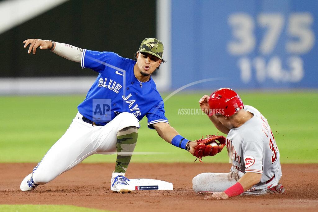 Frank Gunn Cincinnati Reds second baseman Alejo Lopez (35) gets caught stealing by Toronto Blue Jays second baseman Santiago Espinal (5) during the third inning of a baseball game in Toronto, Saturday, May 21, 2022. (Frank Gunn/The Canadian Press via AP)