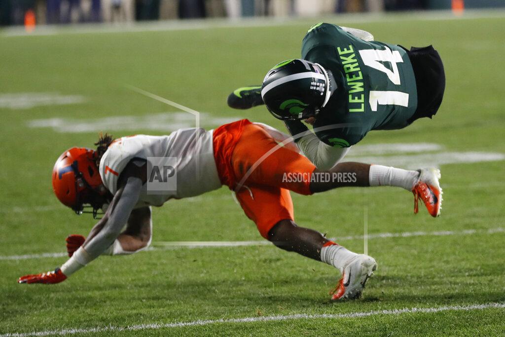 Carlos Osorio Michigan State quarterback Brian Lewerke (14) flips over Illinois defensive back Stanley Green (7) during the second half of an NCAA college football game, Saturday, Nov. 9, 2019, in East Lansing, Mich. (AP Photo/Carlos Osorio)