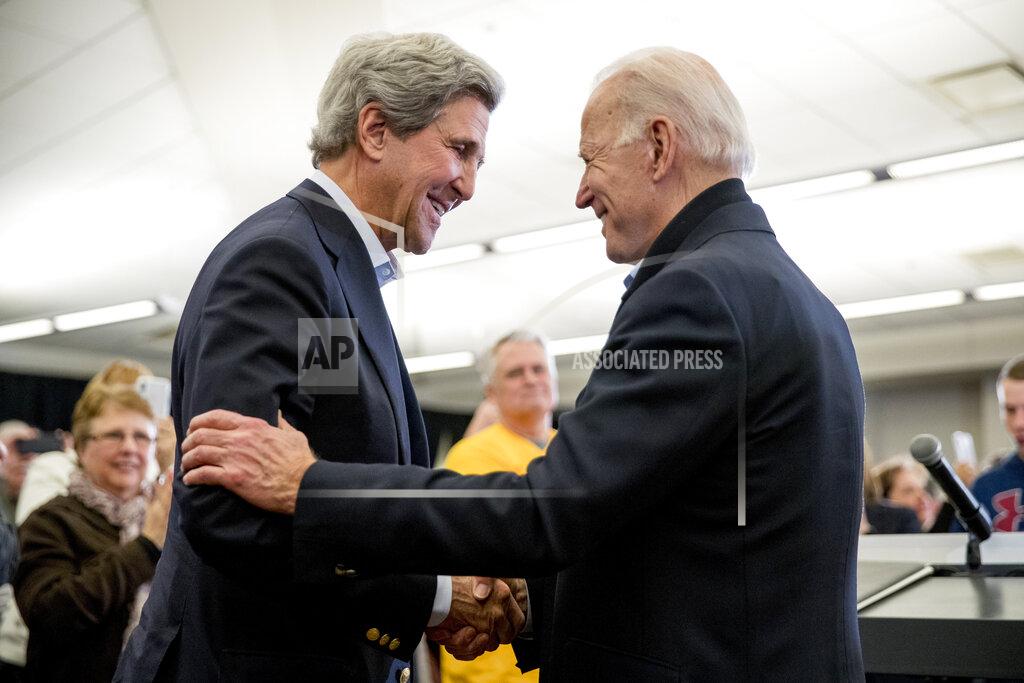 Andrew Harnik FILE - In this Feb. 1, 2020, file photo Democratic presidential candidate former Vice President Joe Biden smiles as former Secretary of State John Kerry, left, takes the podium to speak at a campaign stop at the South Slope Community Center in North Liberty, Iowa. (AP Photo/Andrew Harnik, File)