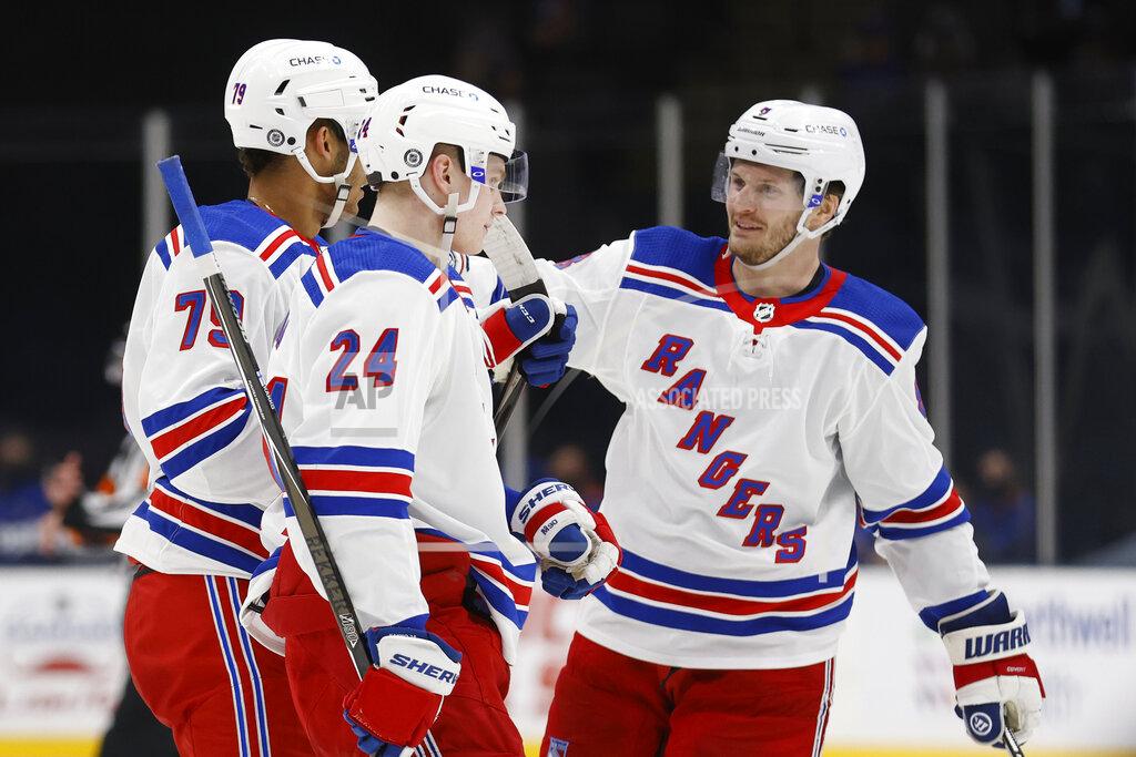 Jason Decrow New York Rangers' K'Andre Miller (79) is congratulated by teammates Jacob Trouba (8) and Kaapo Kakko (24), of Finland, after scoring against the New York Islanders during the third period of an NHL hockey game Friday, April 9, 2021, in Uniondale, N.Y. (AP Photo/Jason DeCrow)