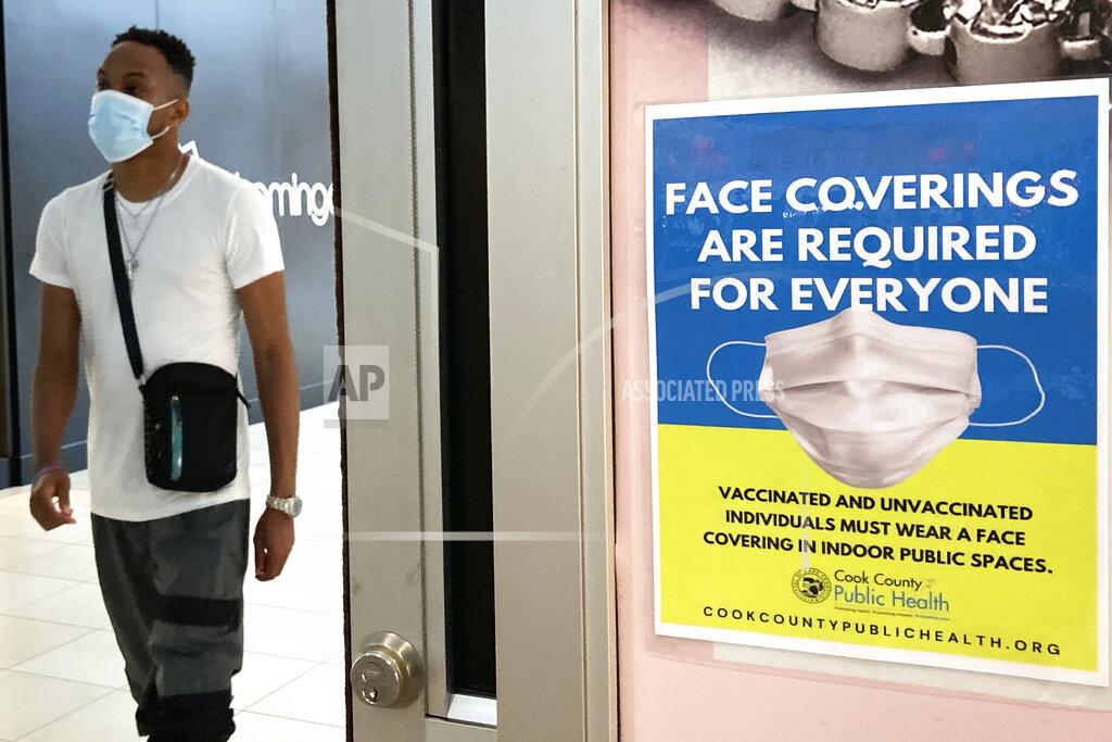 Nam Y. Huh FILE - In this Aug. 26, 2021, file photo, an information sign is displayed at a department store in Rosemont, Ill. The summer that was supposed to mark America’s independence from COVID-19 is instead drawing to a close with the U.S. more firmly under the tyranny of the virus, with deaths per day back up to where they were in March 2021. legal disputes, threats and violence have erupted over mask and vaccine requirements. (AP Photo/Nam Y. Huh, File)