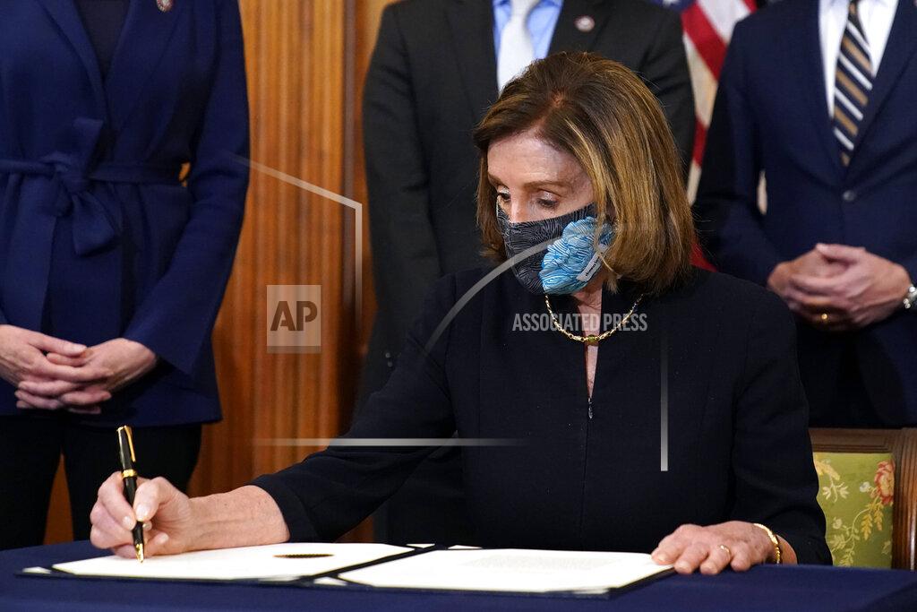 Alex Brandon House Speaker Nancy Pelosi of Calif., signs the article of impeachment against President Donald Trump in an engrossment ceremony before transmission to the Senate for trial on Capitol Hill, in Washington, Wednesday, Jan. 13, 2021. (AP Photo/Alex Brandon)