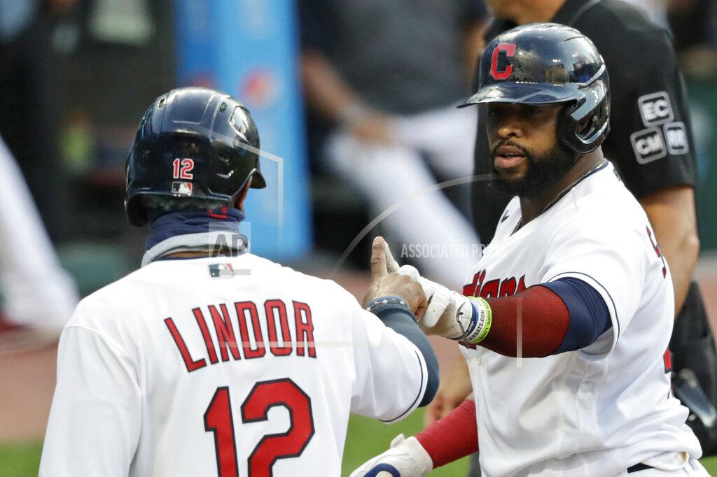 Tony Dejak Cleveland Indians' Carlos Santana, right, celebrates with Francisco Lindor after Santana hit a two-run home run in the first inning in the second baseball game of a doubleheader against the Chicago White Sox, Tuesday, July 28, 2020, in Cleveland. (AP Photo/Tony Dejak)