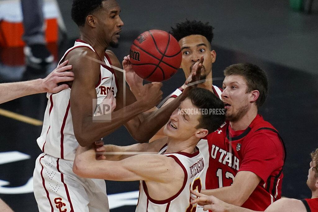 John Locher Southern California's Evan Mobley, from left, Drew Peterson and Utah's Eli Ballstaedt vie fore a rebound during the second overtime of an NCAA college basketball game in the quarterfinal round of the Pac-12 men's tournament Thursday, March 11, 2021, in Las Vegas. (AP Photo/John Locher)