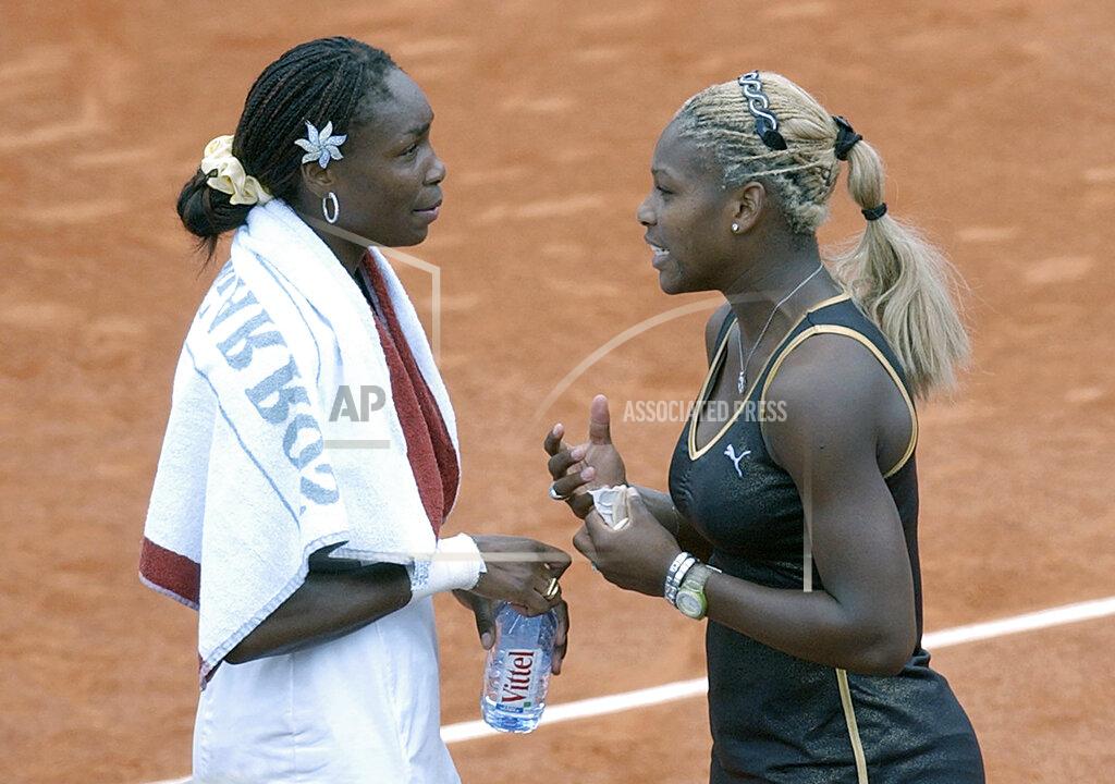 Christophe Ena FILE - In this June 8, 2002, file photo, Serena Williams, right, talks with her sister Venus after Serena won the women's final of the French Open tennis tournament at Roland Garros stadium in Paris. Serena Williams defeated her sister Venus 7-5, 6-3. Serena entered this match with one Grand Slam singles title; she now owns a professional-era record 23. This also began a Sister Slam streak in which Serena beat her older sibling in four consecutive all-in-the-family major finals. Two days after the finale in Paris, they would move atop the rankings together, with Venus at No. 1, and Serena No. 2 -- two people from one household at 1-2 for the only time in tennis history. (AP Photo/Christophe Ena, File)