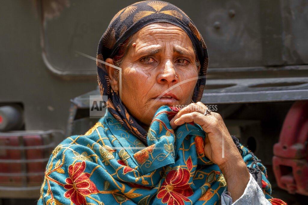 Dar Yasin Tears well up the eyes of Nazira Begum as she awaits news of her nephew, who is among those trapped under a collapsed tunnel, in Ramban district, south of Srinagar, Indian controlled Kashmir, Friday, May 20, 2022. An official in Indian-controlled Kashmir said Friday that 10 workers were trapped after part of a road tunnel collapsed in the Himalayan region. (AP Photo/Dar Yasin)