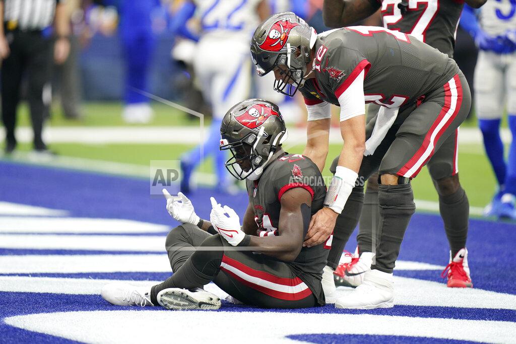 Jae C. Hong Tampa Bay Buccaneers wide receiver Chris Godwin, left, celebrates with quarterback Tom Brady after Godwin scored a touchdown during the first half of an NFL football game Sunday, Sept. 26, 2021, in Inglewood, Calif. (AP Photo/Jae C. Hong)